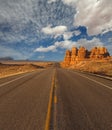 Empty road under a cloudy blue sky in Arizona desert Royalty Free Stock Photo