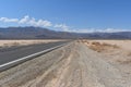 Empty road in the Valley of death, road in the hot desert against the backdrop of mountains, US national park Royalty Free Stock Photo