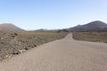 Empty road at volcanic landscape in Lanzarote`s Timanfaya National Park