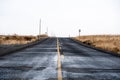Empty road between wheat crop fields Royalty Free Stock Photo