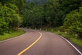 Empty road in wild forest. Summer outdoor travel landscape. Empty highway with green roadside. Royalty Free Stock Photo