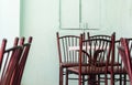 Empty roadside bar terrace with white square tables and wooden b