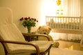 Empty rocking chair in a baby boy room with big teddy bear, crib Royalty Free Stock Photo