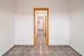 Empty room in apartment with long corridor, tiled floor and white walls Royalty Free Stock Photo