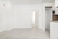 An empty room in an apartment with white walls, light wooden floors Royalty Free Stock Photo