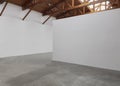 An empty room art gallery with wood ceiling and concrete flooring Royalty Free Stock Photo