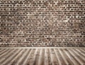 Empty room with brick wall and wooden floor