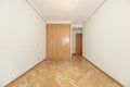 Empty room with built-in wardrobe with four oak folding doors