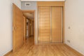 Empty room with built-in wardrobe with sliding wooden doors, Royalty Free Stock Photo