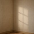 Empty room corner with natural light and window shadow on beige wall Royalty Free Stock Photo
