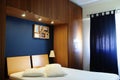 Empty Bed Room with Dark Navy Blue Wall and Wooden Wardrobe Royalty Free Stock Photo