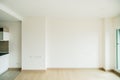 Empty room is decorated with an engineering wooden floor with baseboard and wallpaper on the wall with sunlight from the window. Royalty Free Stock Photo