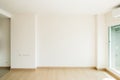 Empty room is decorated with an engineering wooden floor and wallpaper on the wall with sunlight from the window. Minimalist Royalty Free Stock Photo