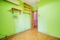 Empty room with green painted walls with wooden shelves and sintasol floors Royalty Free Stock Photo