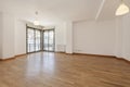 Empty room in a house with oak flooring, corner bay windows on two walls and wooden joinery Royalty Free Stock Photo