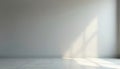 Empty room interior with white wall and light gray floor. Sunlight casts geometric shadows on the wall from a window. Minimalist Royalty Free Stock Photo