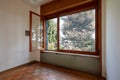 Empty room interior with wooden floor and large open window