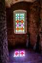 An empty room with light coming through multicolored stained glass windows. Royalty Free Stock Photo