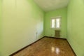 Empty room with light green painted walls, metal radiator Royalty Free Stock Photo