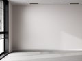 Empty room with light walls, window and concrete floor. Empty room for mockup, empty wall mock up, empty room with sunlight and Royalty Free Stock Photo
