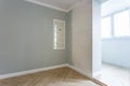 Empty room with minimal preparatory repairs with crown molding. interior of white and gray walls