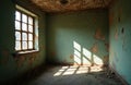 Empty room in old abandoned house with peeling paint walls, broken ceiling. Bright sunlight streams through large window casting Royalty Free Stock Photo