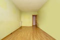 Empty room in an old flat built with modest qualities, pistachio green painted walls and wooden floors Royalty Free Stock Photo