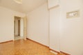 Empty room with a patterned orange vintage stoneware floor and a small wall-mounted safe