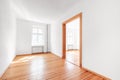 Empty room in renovated apartment flat with wooden boardfloor and white walls