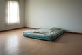 an empty room with a single mattress on the floor