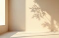 Empty room with soft beige walls and floor. Sunlight casts leaf shadows on surface. Ideal for backdrop or product display in Royalty Free Stock Photo