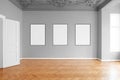 Empty room with three blank picture frames hanging on wall in apartment Royalty Free Stock Photo