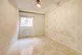 Empty room with wallpapered wall with tiled floors and simple aluminum window