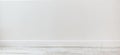 Empty room with white cement wall texture and white wooden floor pattern. Royalty Free Stock Photo