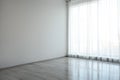 Empty room with white wall, large window and floor