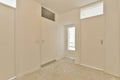 a bedroom with white walls and a window and door