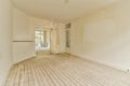 an empty living room with wood floors and white walls Royalty Free Stock Photo