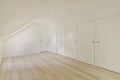 a room with white closets and a wooden floor Royalty Free Stock Photo