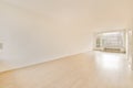 an empty living room with wood floors and a window Royalty Free Stock Photo