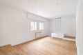 Empty room with window and hardwood floor after renovation. New apartment for rent or sale. Royalty Free Stock Photo