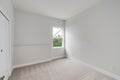 Empty room with a window, white painted walls, carpet floor and built-in closet Royalty Free Stock Photo