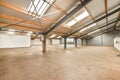 a large warehouse with a concrete floor and exposed ceilings Royalty Free Stock Photo