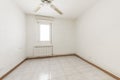 Empty room with wooden baseboards with white ceramic flooring,