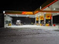 An empty Rosneft fuel station on a winter night during a heavy snowstorm. Royalty Free Stock Photo