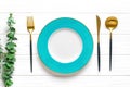 Empty round blue plate, fork, knife, spoon, sprig of eucalyptus on wooden table Top view Flat lay Dishes for breakfast, lunch or Royalty Free Stock Photo