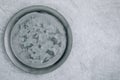 Empty round metal plate on gray concrete background, top view Royalty Free Stock Photo