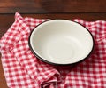 Empty round metal white plate stands on wooden brown table Royalty Free Stock Photo