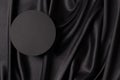 Empty round platform podium on beautiful black color background with drapery and wavy folds of silk satin material. Mock Royalty Free Stock Photo