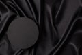 Empty round platform podium on beautiful black color background with drapery and wavy folds of silk satin material. Mock Royalty Free Stock Photo