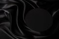 Empty round platform podium on beautiful black color background with drapery and wavy folds of silk satin material. Mock Royalty Free Stock Photo